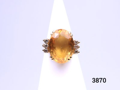 Modern 18karat gold ring set with a large oval cut citrine set on a high bridge with 3 small round cut diamonds to either side. Hallmarked 18k on inside band. Ring size N / 6.5 Ring weight 9.1 grams. Box included. Main photo of ring on a cone shaped display stand and seen from the front