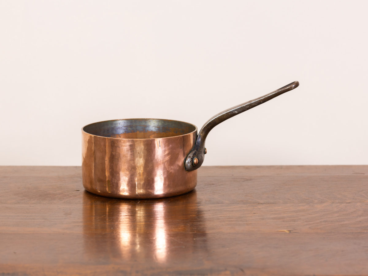 Vintage French copper pan. Heavyweight saucepan in copper with wrought iron handle. Pan interior is iron with copper coating which has faded at the top of the pan. Should last a few more decades. Measures 185mm in diameter at base and 97mm deep.