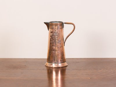 Art Nouveau solid copper jug. Medium sized handmade copper jug with classic Art Nouveau decoration to both sides. Made by Joseph Sankey & Sons of Albert Street, Bilston. Early 20th Century. Measures approximately 120mm in diameter at base and 70mm in diameter at opening at top.
