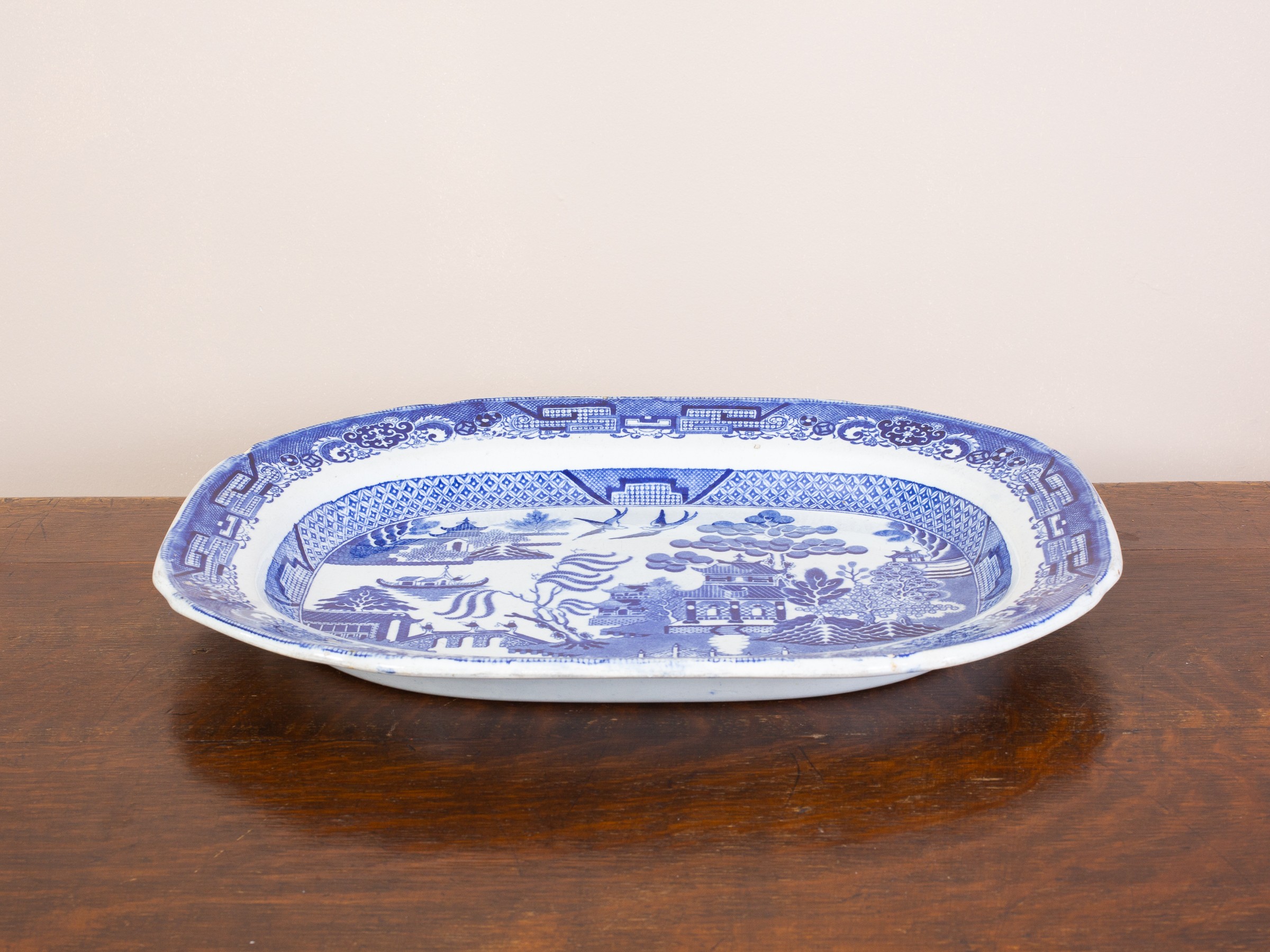 Large antique blue and white transfer ware platter. 19th Century meat platter in the 'Willow Pattern' Several chips to the glaze.
