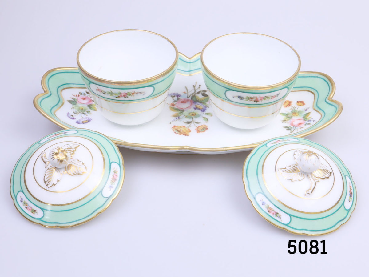 Antique 19th century Paris porcelain double condiment pots on a tray. Identical sized lidded condiment containers attached to a decorative tray. Floral design with peppermint green and gilt. In excellent condition throughout with minor marks inside the pots only. Pots measure 82mm in diameter across the top. Photo with lids removed from the pots and placed leaning up in the foreground by the foot of each pot