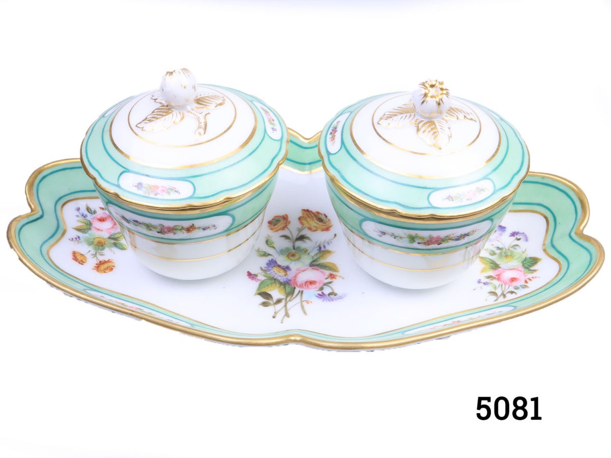 Antique 19th century Paris porcelain double condiment pots on a tray. Identical sized lidded condiment containers attached to a decorative tray. Floral design with peppermint green and gilt. In excellent condition throughout with minor marks inside the pots only. Pots measure 82mm in diameter across the top. Photo of pots with lids in place and seen from a slightly raised angle showing the floral decoration on the plate