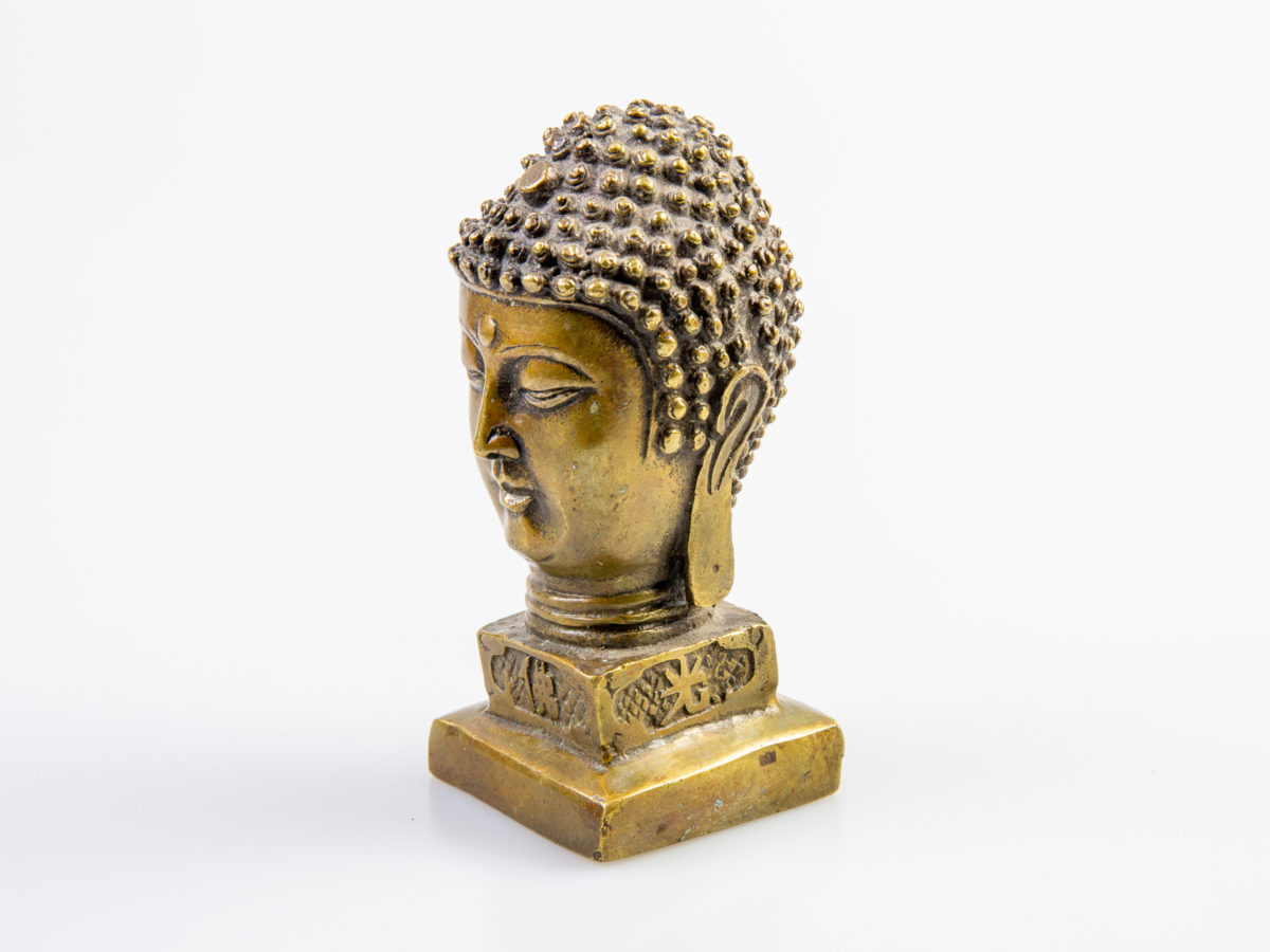Vintage small brass Buddha head seal. Compact desk seal in solid brass with Chinese characters to the 4 sides below the head reading "The Light of Buddha Enlightens Broadly" Measures 42mm square at base and 50mm at widest point Photo of Buddha head from a diagonal angle