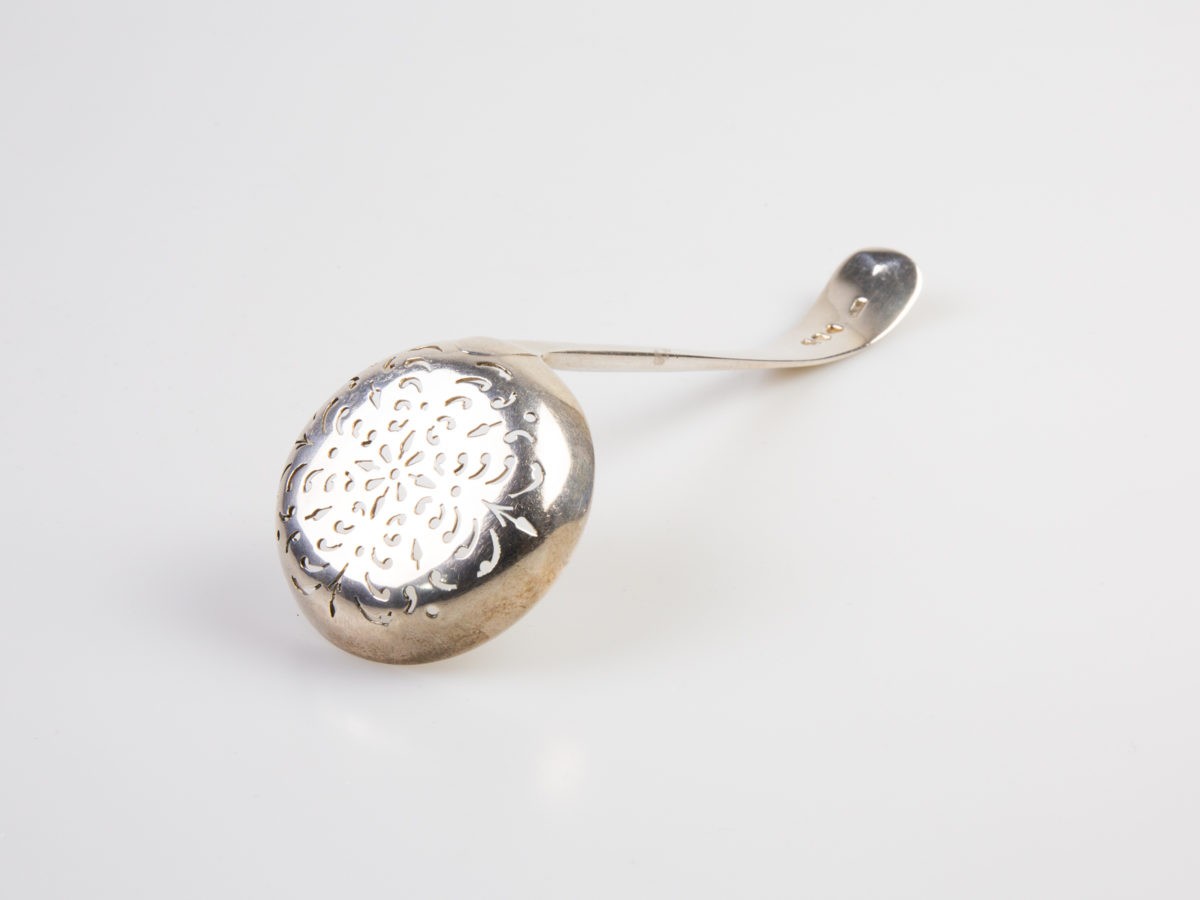 c1894 antique Victorian sterling silver sifter spoon. London assayed fully hallmarked sifter spoon made by Josiah Williams (George Maudsley Jackson) Spoon bowl measures 50mm in diameter Photo of spoon face down and laid diagonally with strainer end in the bottom left corner