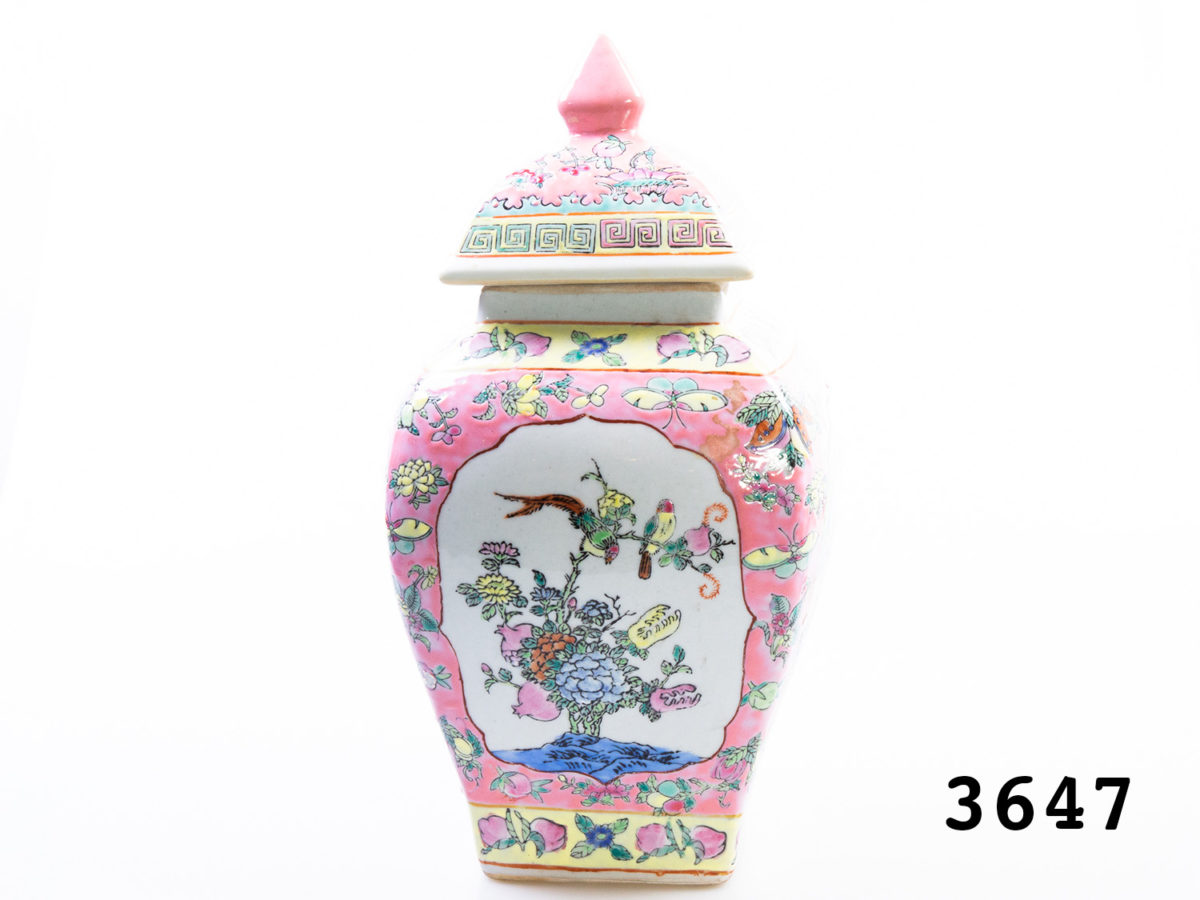 Vintage Chinese ginger jar. Unusual square based Famille Rose ginger jar with lid in mainly pink.Pictures to the sides alternating of Oriental figures or exotic birds and plants. Stamped to the base. Measures 95mm square at base and 170mm at widest point. Photo of jar showing the exotic birds and flowers side