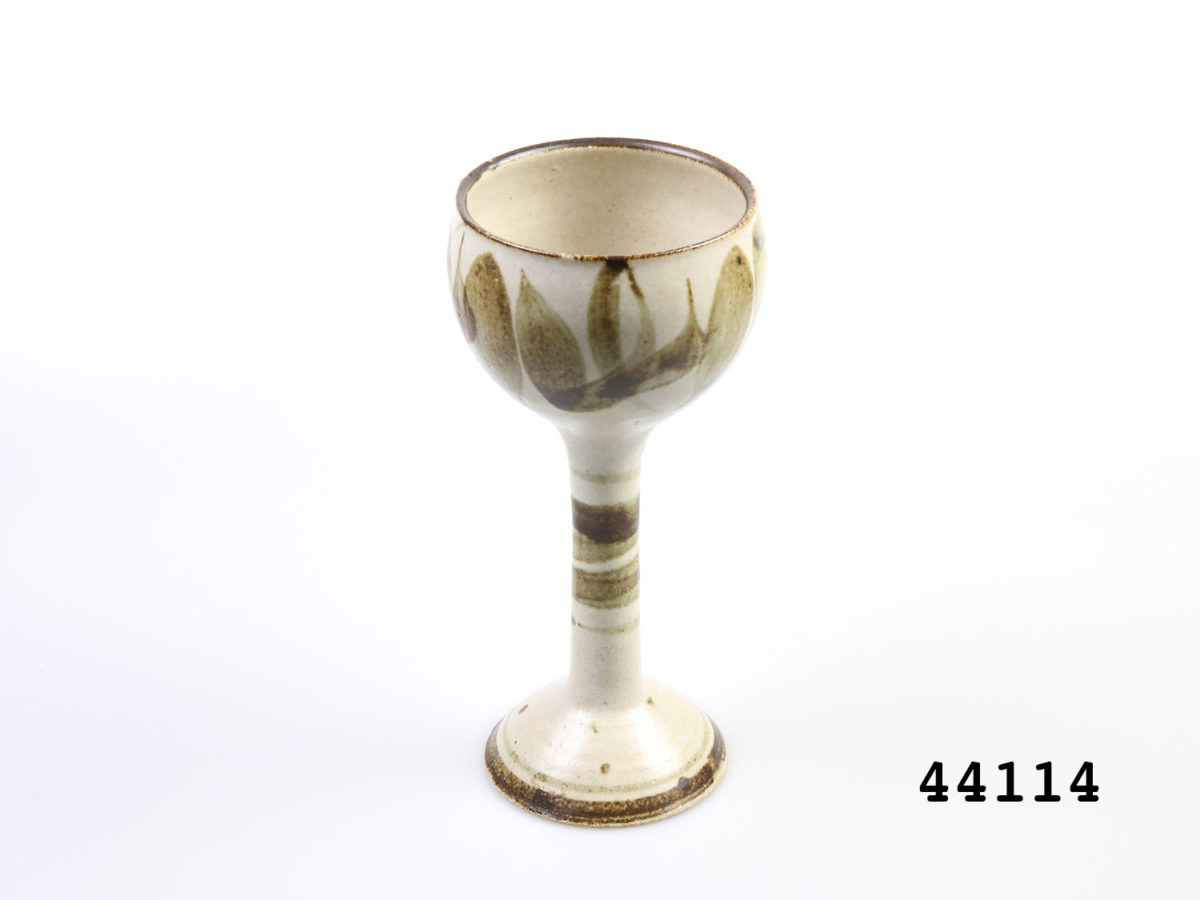 c1960s vintage German Studio Pottery goblets. Pair of tall goblets in earthy colours and design. Each goblet measures approximately 88mm in diameter at base and 95mm in diameter across the mouth. Photo of a goblet from a slightly raised angle