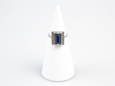 Vintage Art Deco style ring. Hallmarked 935 silver ring with a rectangular cut royal blue glass stone to the centre. Ring size M.5 / 6.5 Main photo of ring displayed on a cone display stand with ring front facing forward