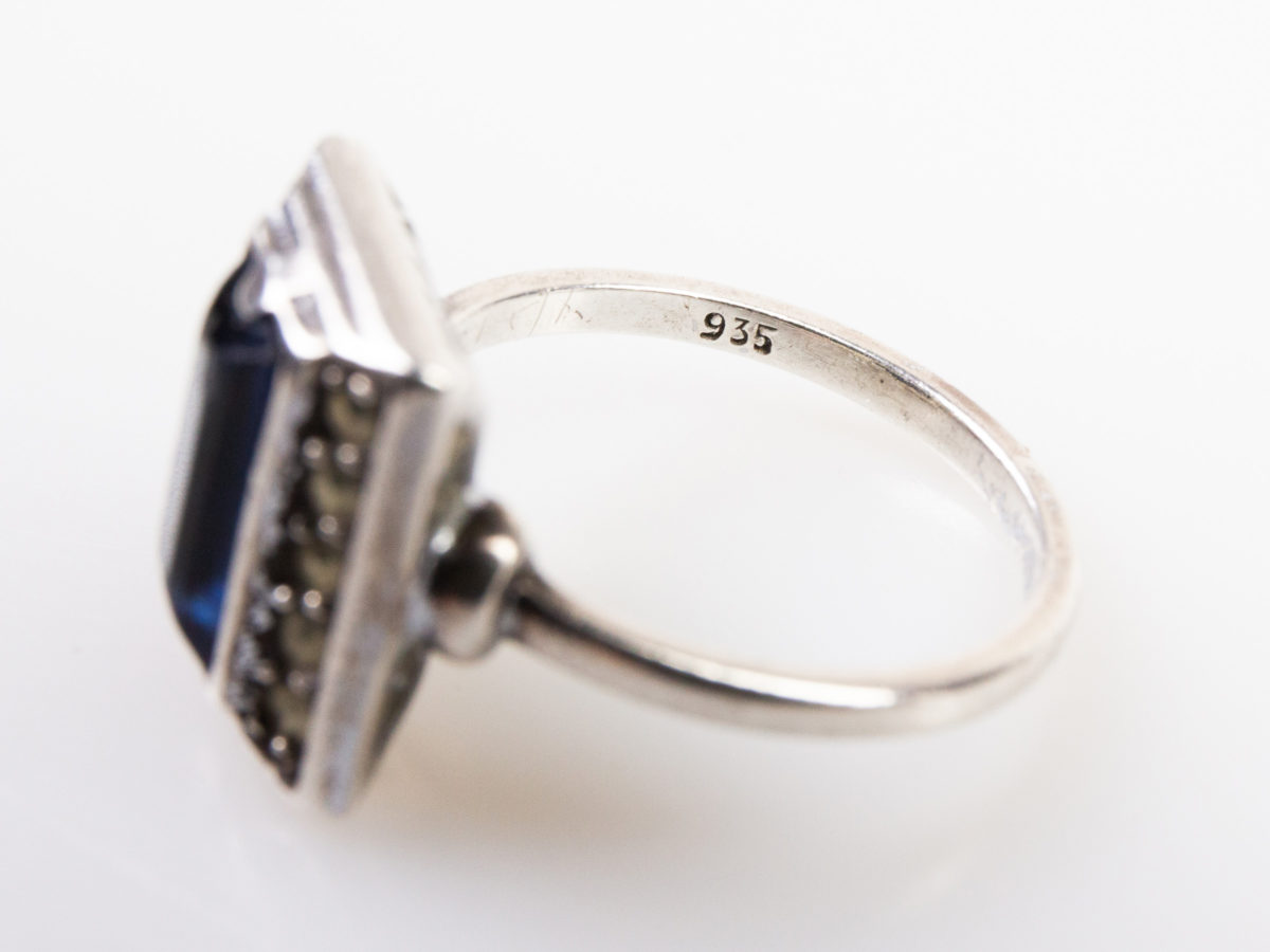 Vintage Art Deco style ring. Hallmarked 935 silver ring with a rectangular cut royal blue glass stone to the centre. Ring size M.5 / 6.5 Close up photo of the 935 hallmark on the inside band