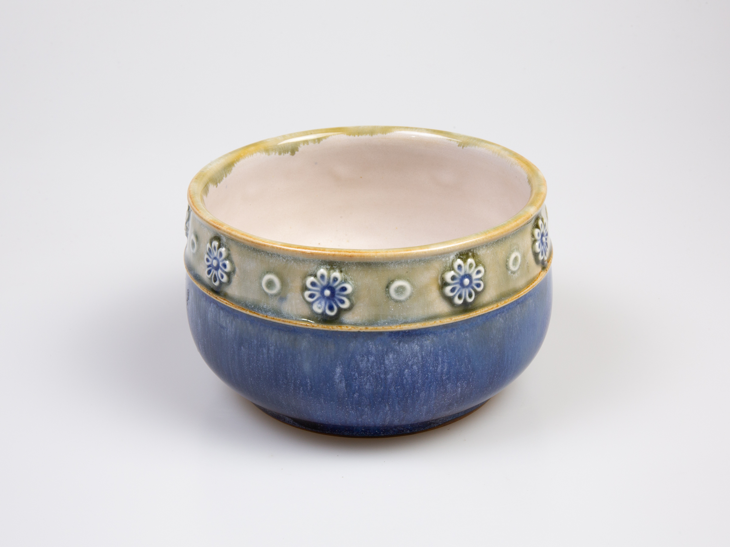 c1923 to 1927 small Royal Doulton bowl. Pretty bowl in iconic Doulton colours. Marked 8200 and accredited to artist Louisa Ayling. Measures approximately 85mm in diameter at base and 110mm across the top. Main photo of bowl seen from a slightly raised eye level angle