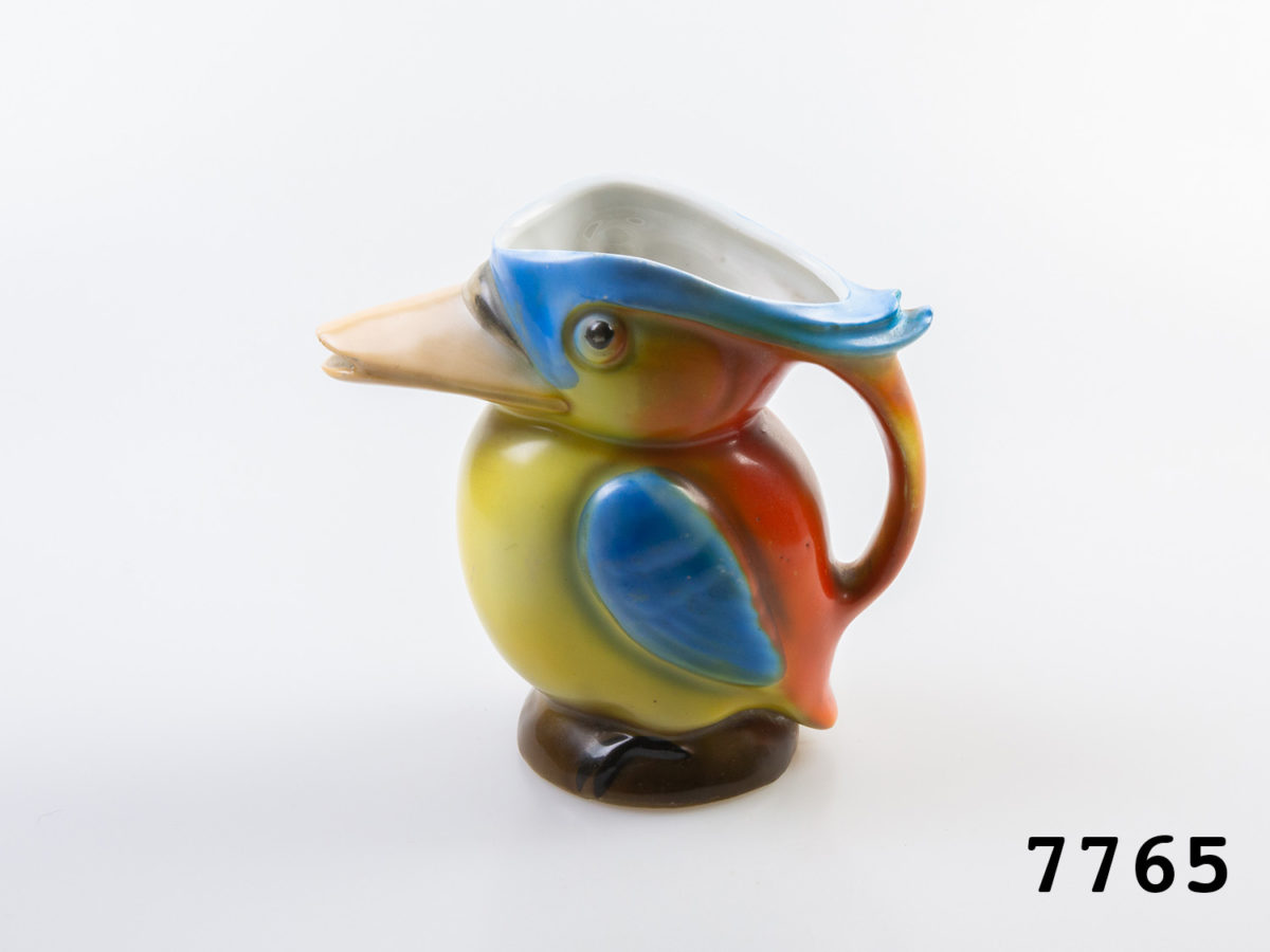 1940s vintage creamer jug in the form of a colourful Kingfisher bird. Colourful jug in the form of a toucan with beak as spout. Measures 62mm in diameter at base and 125mm at widest point from spout tip to handle edge. Main photo of jug with bird facing left