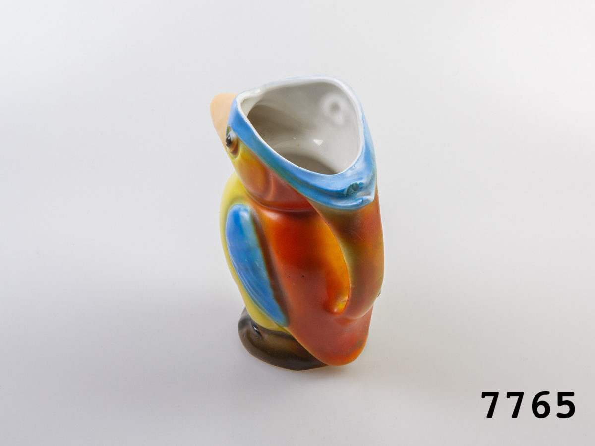 1940s vintage creamer jug in the form of a colourful Kingfisher bird. Colourful jug in the form of a toucan with beak as spout. Measures 62mm in diameter at base and 125mm at widest point from spout tip to handle edge. Photo of jug mainly from the back handle area
