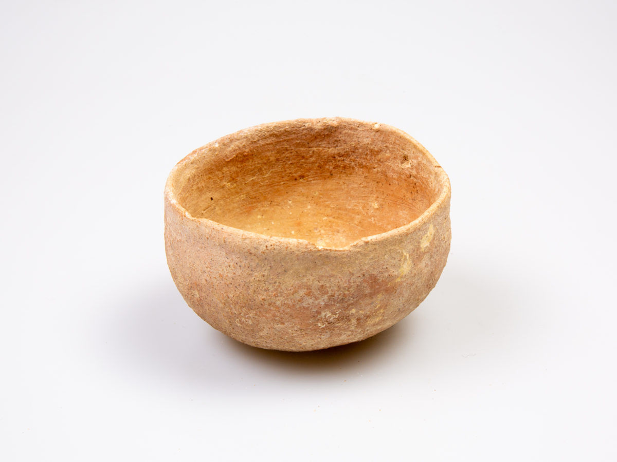 Bronze age terracotta votive cup. Circa 800-600 BC. Also known as a nipple cup. In superb condition. Measures approximately 66mm in diameter across the mouth. Photo of cup from slight raised angle slightly showing the inside lip