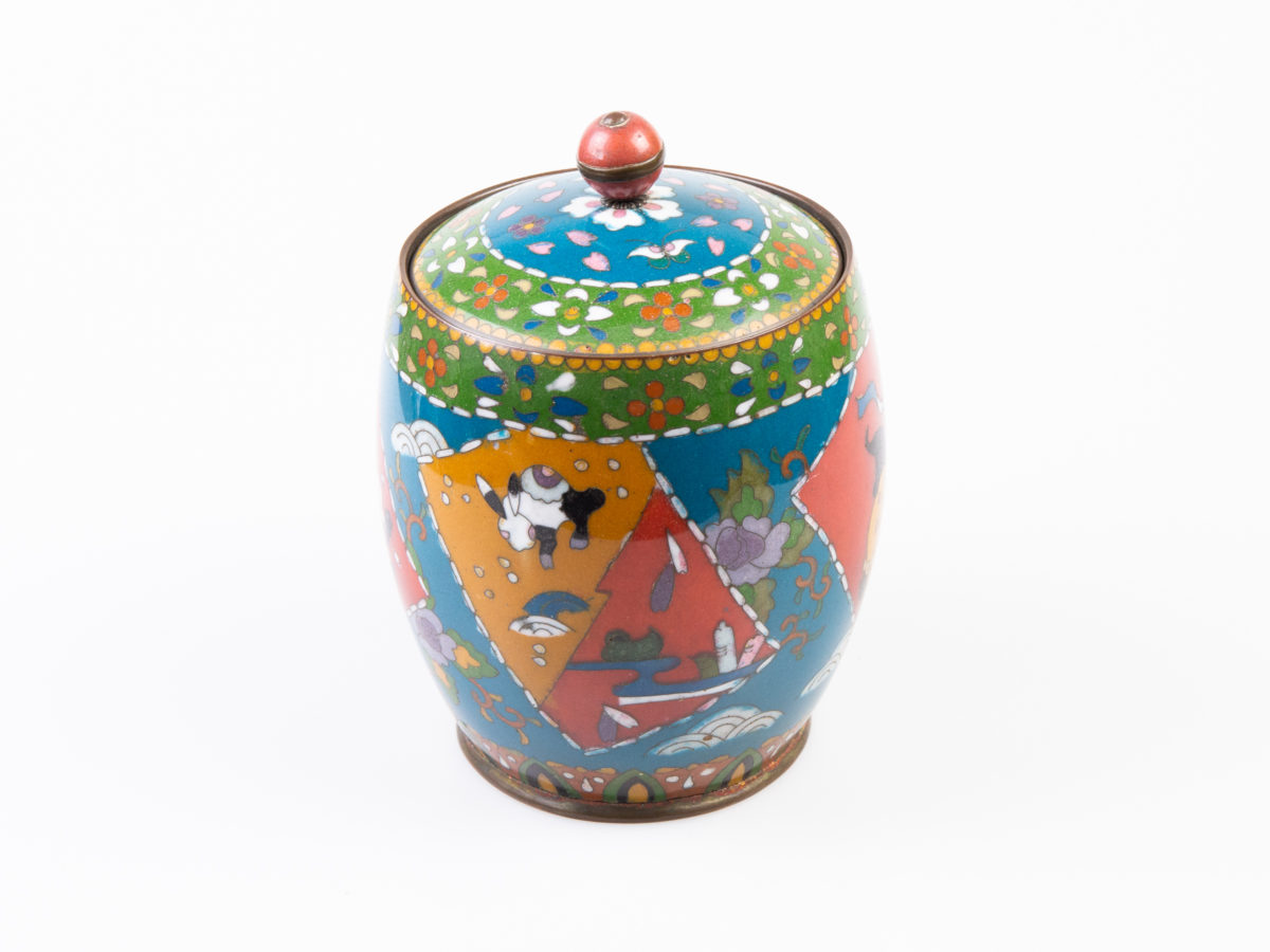Early 20th century lidded cloisonne jar. Good sized jar in unusually muted colours for cloisonne which adds to the attractiveness of the jar. Decorated with flora and fauna to the side. Enamel in excellent condition. Finial is a little loose on the lid & needs attention. Measures 88mm in diameter at base, approximately 120mm in diameter at widest part and 165mm tall with lid. Photo of one side of jar with rabbit