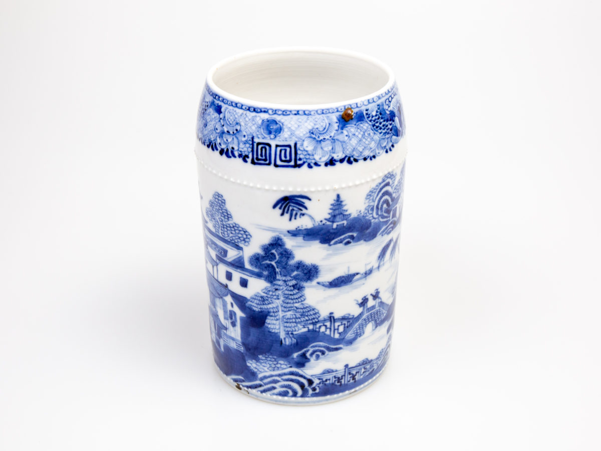 Antique Chinese blue and white tall mug. Rare mug from the Qianlong Li era c1736-1795. Decorated in classic willow pattern with an intricate and unusual 2 pleat handle. Small chip of the paint on the outer pleat handle and what appears to be a crack but most likely a consequence of the manufacturing process on the top of the inner pleat handle.  Otherwise in excellent condition for its age. Measures 82mm in diameter at base, 72mm across the top and 130mm at widest. Photo of the side of mug opposite the handles side