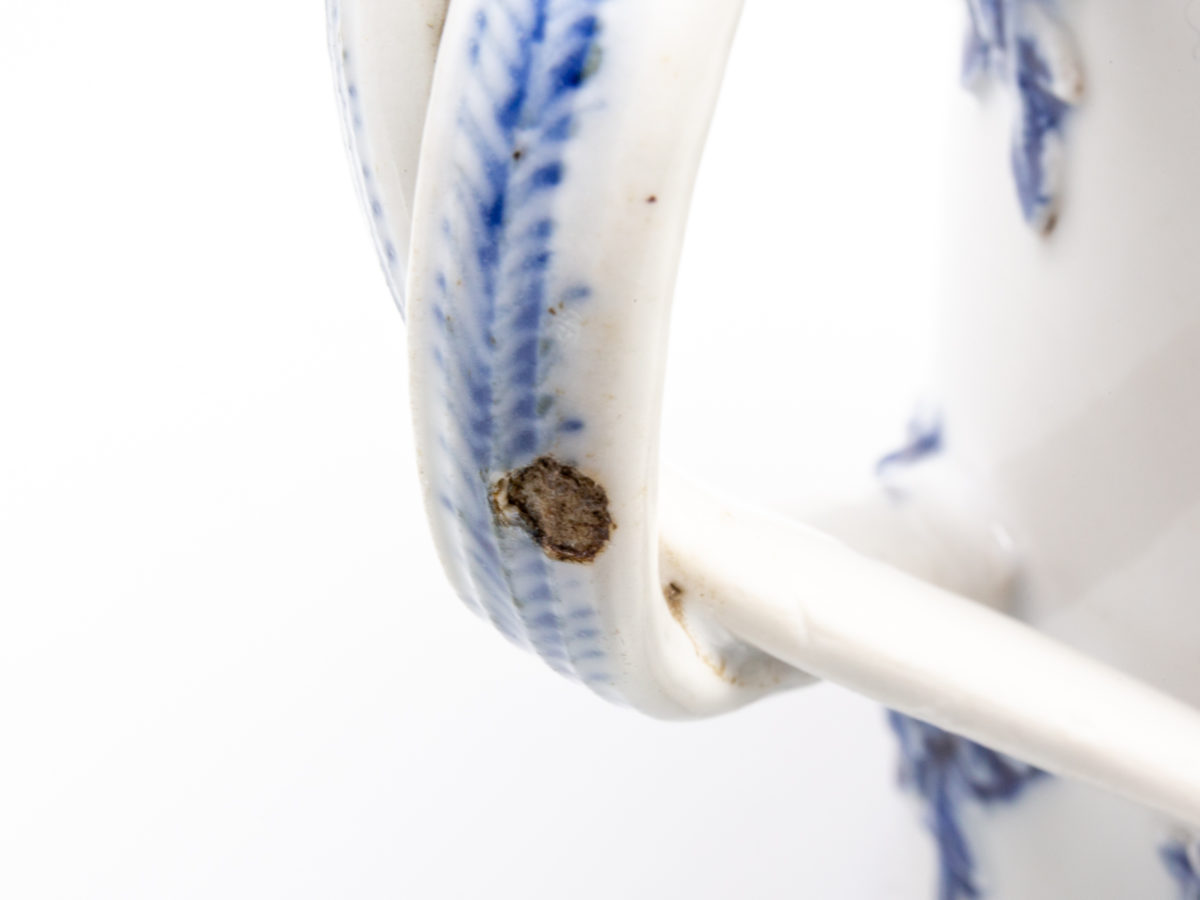 Antique Chinese blue and white tall mug. Rare mug from the Qianlong Li era c1736-1795. Decorated in classic willow pattern with an intricate and unusual 2 pleat handle. Small chip of the paint on the outer pleat handle and what appears to be a crack but most likely a consequence of the manufacturing process on the top of the inner pleat handle.  Otherwise in excellent condition for its age. Measures 82mm in diameter at base, 72mm across the top and 130mm at widest. The small round chip on the outer pleat handle