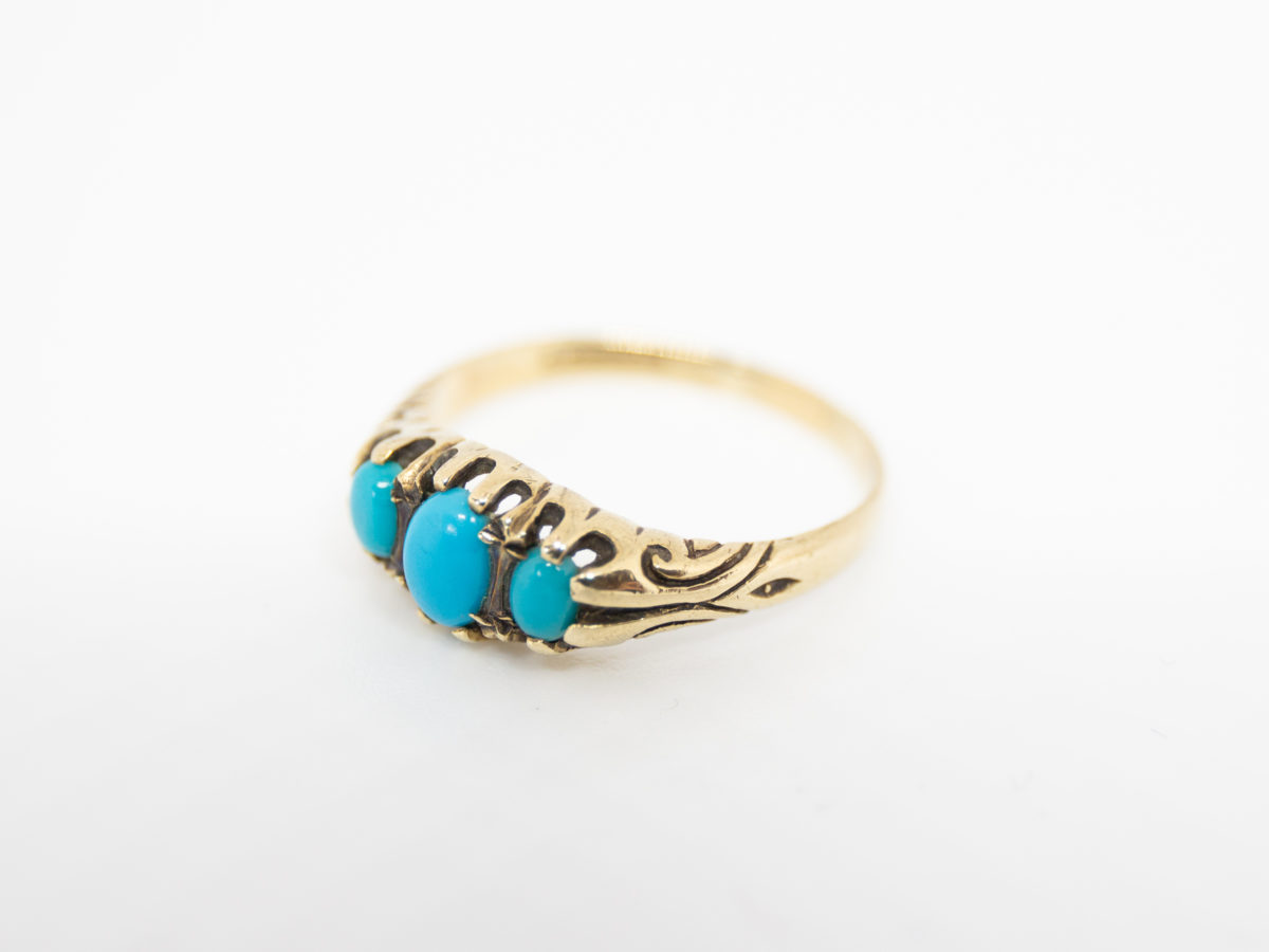 Vintage 9 karat gold and turquoise ring. Fully hallmarked 9 karat gold ring set with 3 sleeping beauty turquoise stones. Birmingham assay c1990. Ring size Q / 8.  Ring weight 2.4grams Photo of ring displayed on a flat surface and seen from a slight side angle