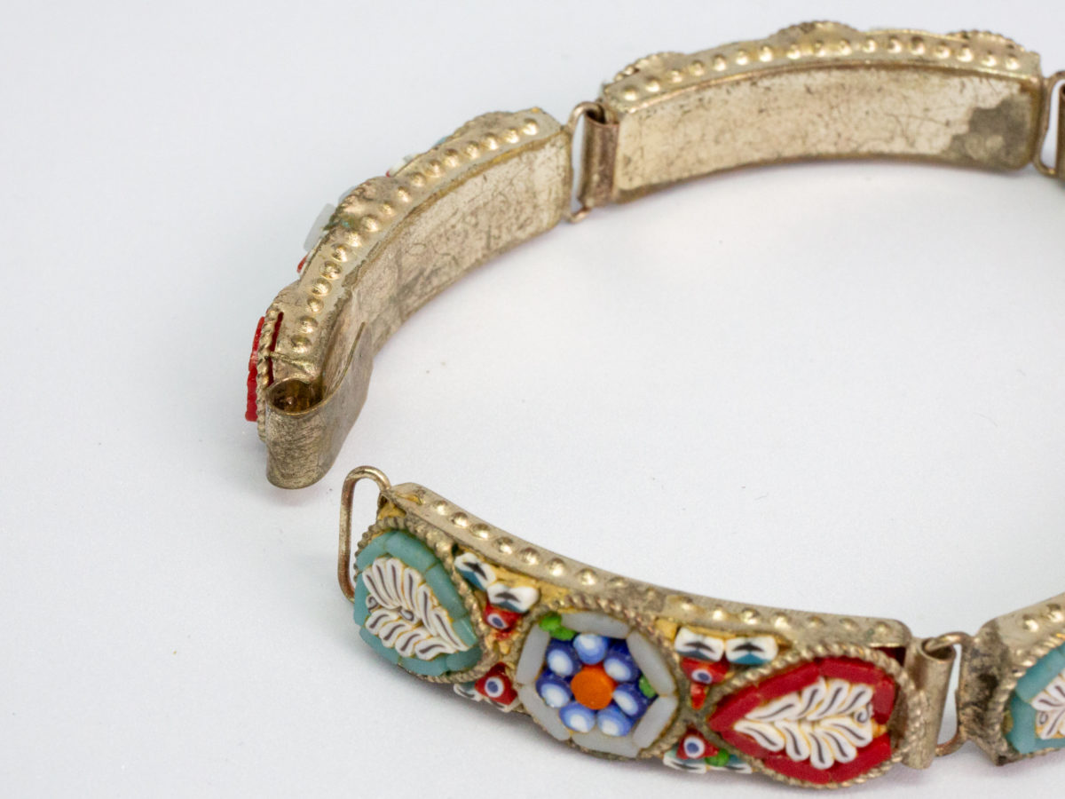 Vintage Italian micro mosaic bracelet. 5 panel white metal bracelet inlaid with micro mosaic beads in a pretty floral design. In very good order throughout with only 1 small bead missing. Photo of clasp area with bracelet open