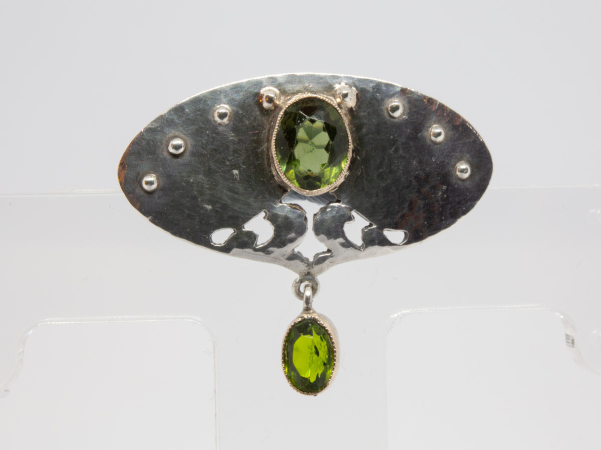 Art Nouveau brooch in 950 grade silver and peridot. Fine Art Nouveau brooch by Murrle Bennett & Co in a classic Art Nouveau design with 2 oval cut peridot stones. Hallmarked to the back. Photo of brooch front shown right way up.