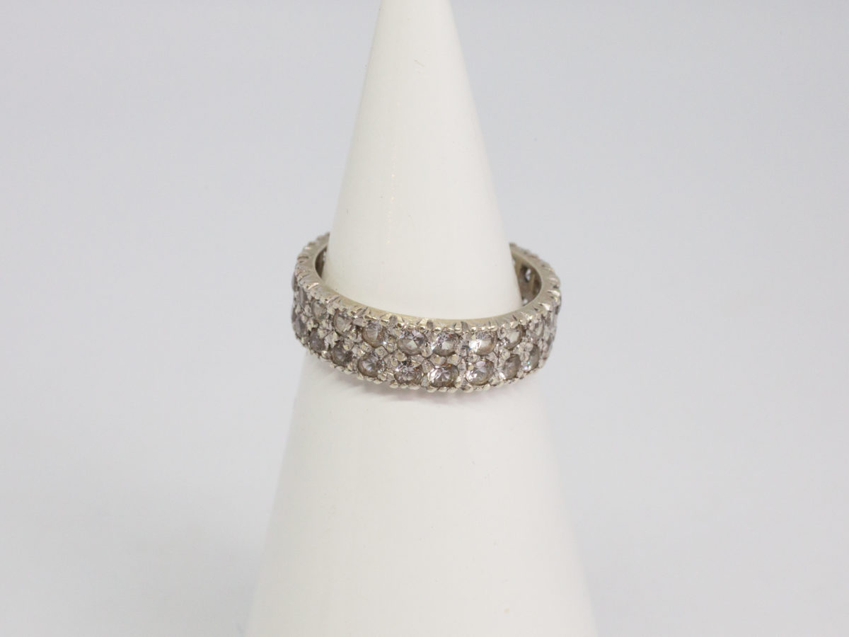 9 karat white gold & spinel ring. White gold ring with 2 rows of spinel stones that go all around. Beautifully sparkly ring for any occasion. Ring size K / 5.25. Main photo of ring displayed on a cone shaped stand