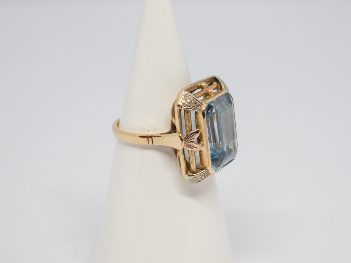 Antique 18 karat gold ring with blue topaz. c1920s large statement ring set with a large emerald cut pale blue topaz. Ring size R.5 / 8.75 Ring weight 8.6gms Photo of ring displayed on a cone stand with ring front facing right of photo