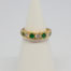 18 Karat gold, emerald and diamond. c1975 London assayed ring set with 5 round cut diamonds and 4 emeralds. Size O.5 / 7.25. Weight 3.8gms. Box included. Main photo of ring displayed on a cone stand and seen from the front