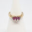 Dainty 9 karat gold and ruby. Sweet and delicate ring set with 3 marquise cut rubies with small round cut diamond to either side. Ring size M / 6.25 Weight 2.4gms. Box included. Main photo of ring displayed on a cone stand and seen from the front.
