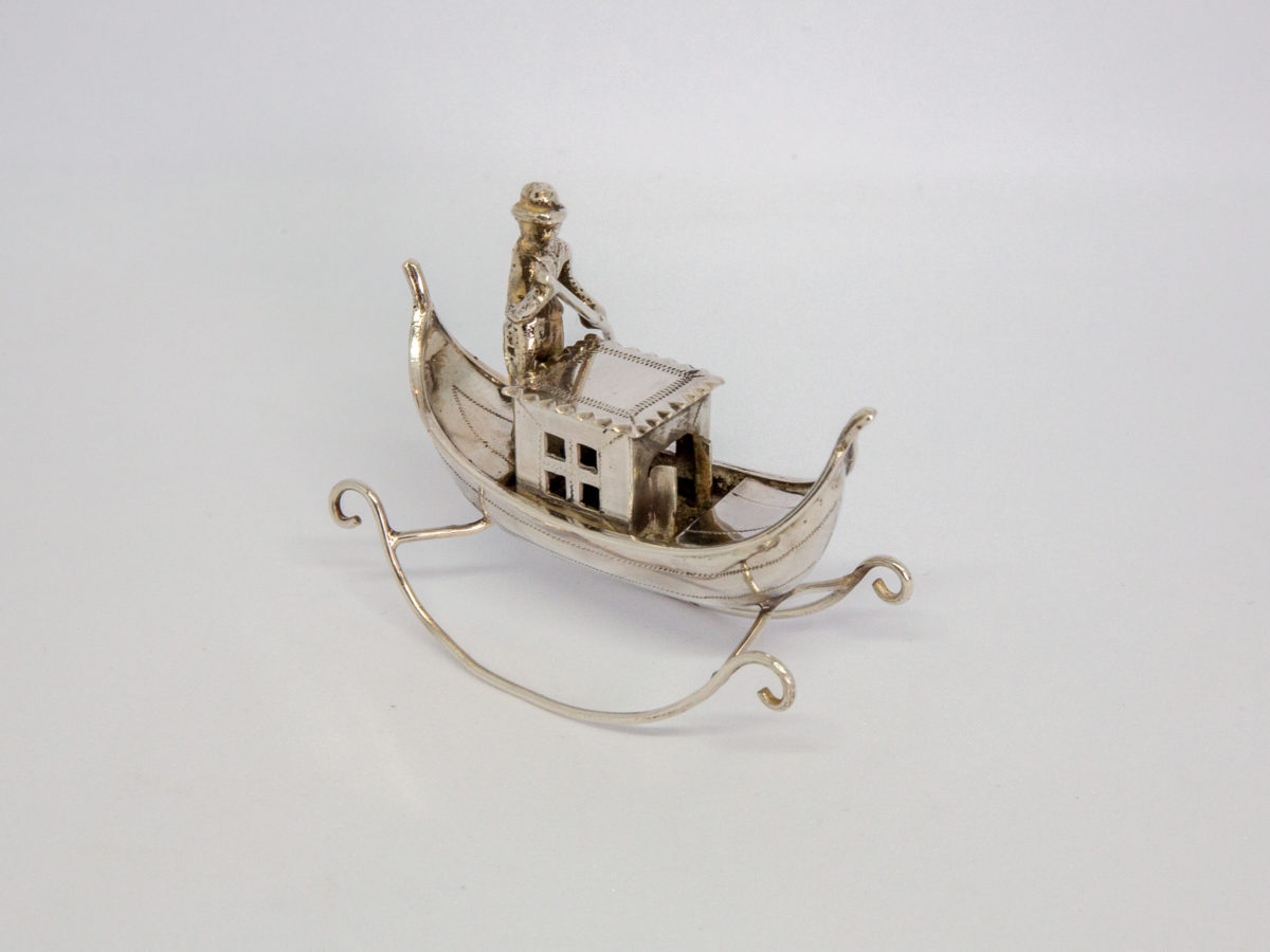 Vintage Dutch silver novelty gondolier. Solid silver decorative piece with full Dutch hallmark to the base. Photo of gondolier at an off side angle with front of gondola facing bottom right of photo