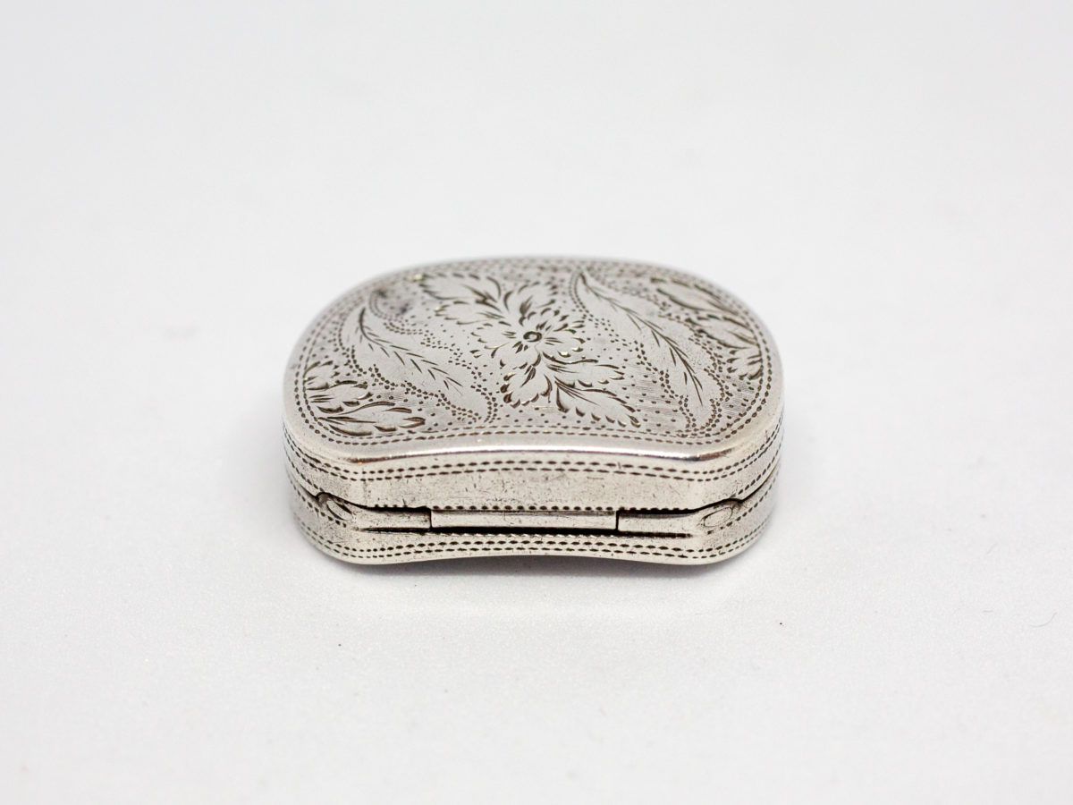 c1807 George III silver vinaigrette. An oblong sterling silver vinaigrette with a curved bottom and a gilt silver interior and grille. Fully hallmarked to the inside of lid for Birmingham assay by silversmith Cocks & Bettridge. A couple of minor dings but closes tight. Photo of back hinged area of vinagrette