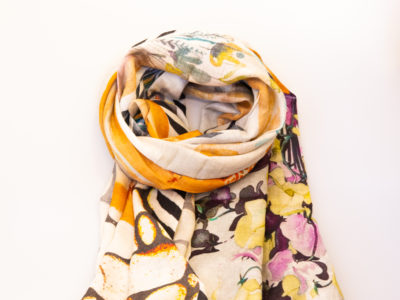 Modern hand-woven mixed fibre scarf. Luxurious hand-woven scarf in modal, wool, silk & cashmere-incredibly soft to the touch you can hardly feel it! Design is hand-printed using traditional methods of silk screen and lithographic wood block and shows pottery pieces with flowers. An absolutely gorgeous gift for someone special. Main photo of scarf rolled up as if around a neck