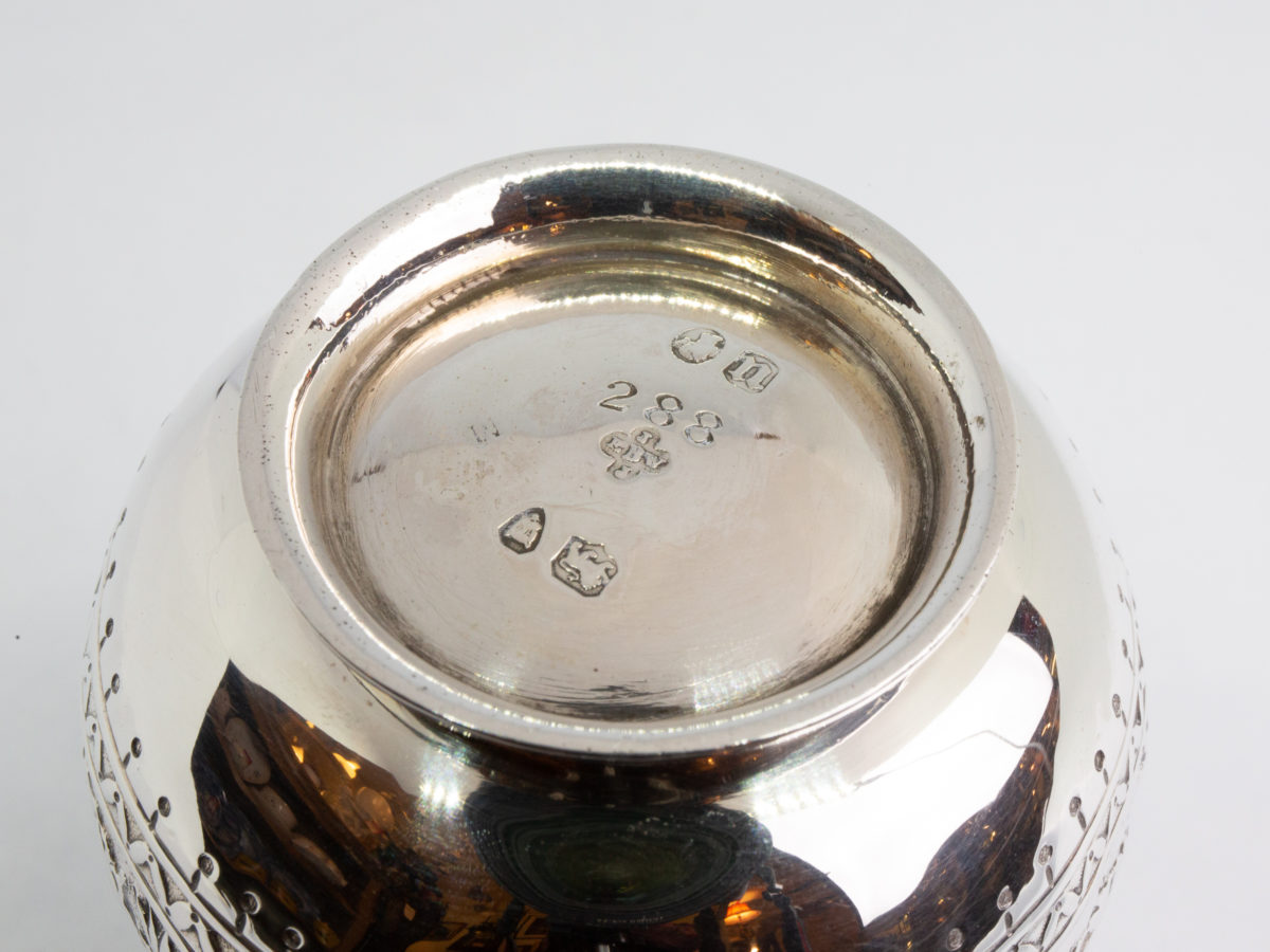 c1875 Small sterling silver jug. Very sweet and finely decorated small jug by Barnard & Sons Ltd. Full hallmark to the base for London assay. Stunning piece with empty cartouche to either side for personalisation. Measures 40mm in diameter at the base, 85mm from tip of spout to edge of handle and 45mm across the top. Close up photo of the bottom of jug showing hallmark