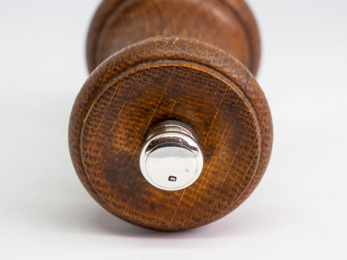 c1932 Small pepper grinder. Petite pepper grinder with oak body and silver top and base rim. The best in pepper grinders with a Peugeot movement. Hallmarked to the base for Birmingham assay and made by John Grinsell & Sons. Lion passant to the top. Measures 45mm in diameter at base and 42mm in diameter at top. Photo of lion passant mark on the top of the grinder