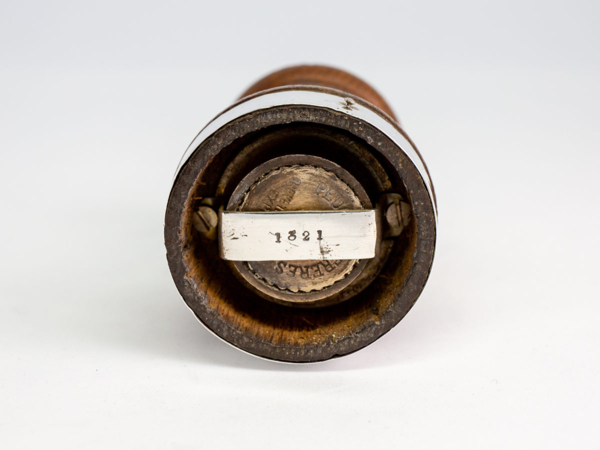 c1932 Small pepper grinder. Petite pepper grinder with oak body and silver top and base rim. The best in pepper grinders with a Peugeot movement. Hallmarked to the base for Birmingham assay and made by John Grinsell & Sons. Lion passant to the top. Measures 45mm in diameter at base and 42mm in diameter at top. Photo of base of grinder