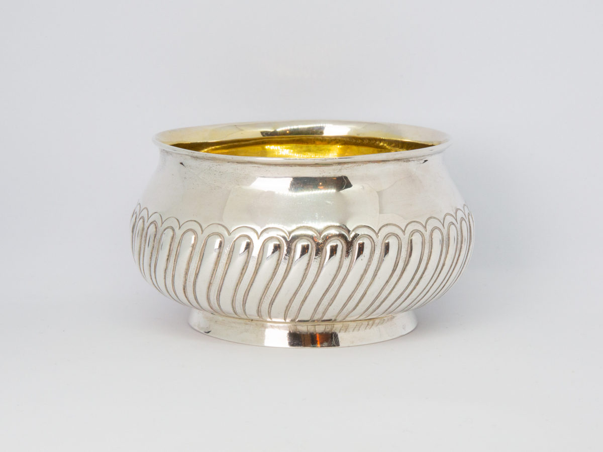 Edinburgh assayed sterling silver bowl. Lovely bulbous bowl with nice raised decorative work to the outside and a gilt silver interior. Fully hallmarked to the base and made by Hamilton & Inches c1881. Measures 80mm in diameter at base, 100mm across the top and approximately 120mm at bulbous central part. Main photo of the bowl shown from a near eye level angle with a hint of gilt interior showing.