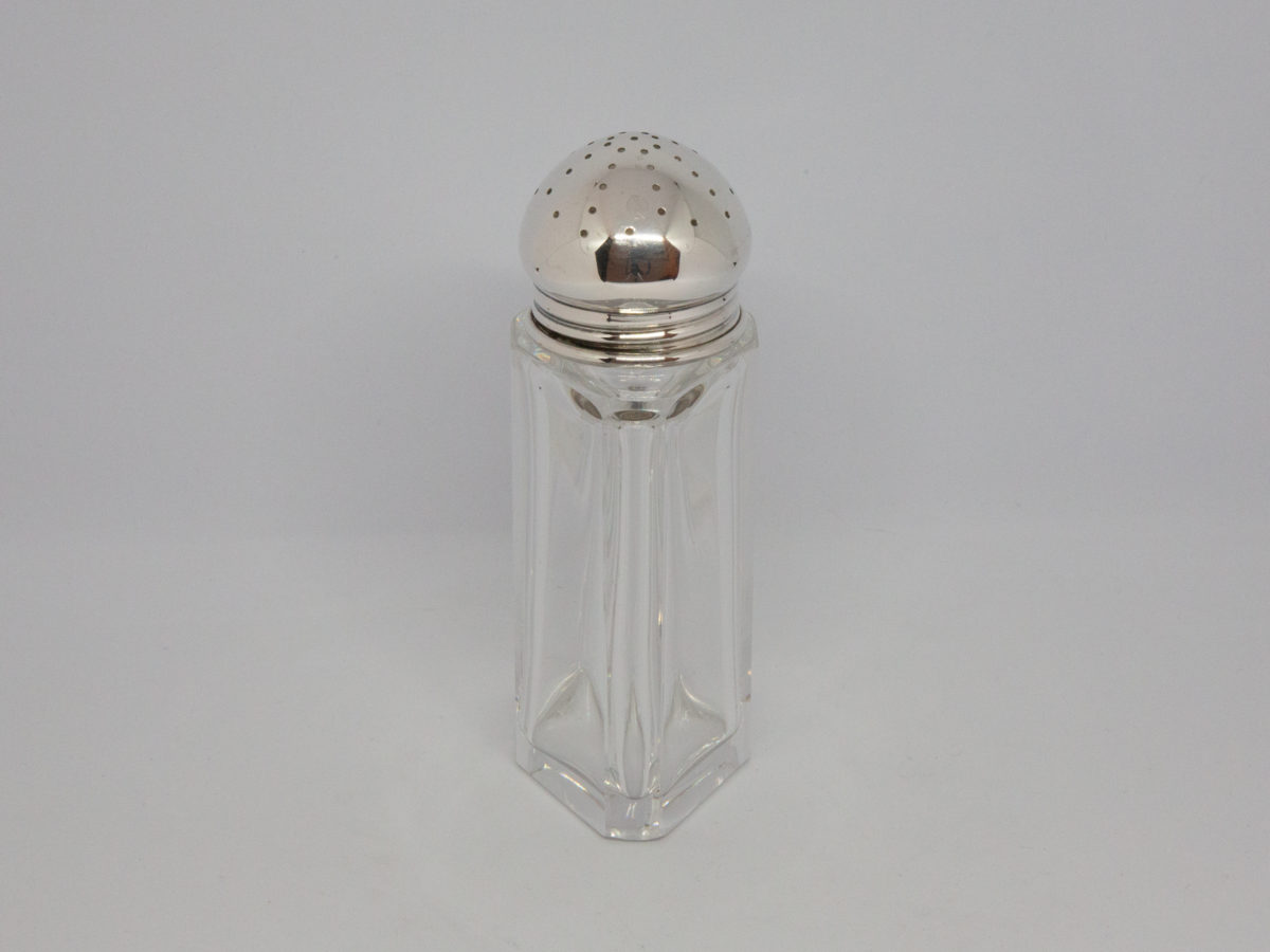 Continental silver topped sugar sifter. Lovely Deco sugar sifter with heavy crystal glass bottom and 835 silver top. Full hallmark to the side of the silver top believed to be of German origin. In excellent condition with no chips or cracks. Photo of sifter shown from a sideways angle.