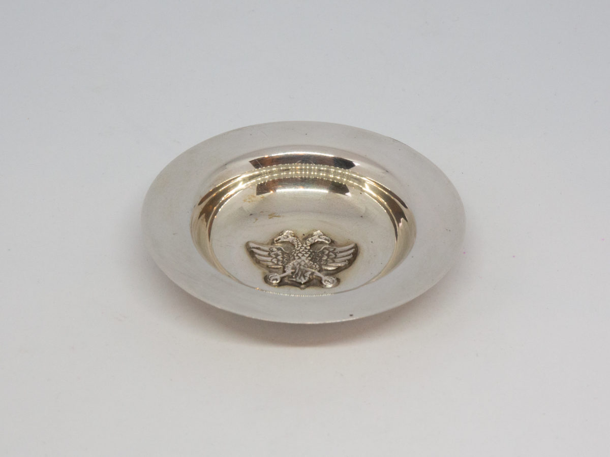 Vintage Scandinavian silver dish. Small round silver dish with a two-headed eagle to the centre. Hallmarked 830 Silver to the base. Measures 55mm at base and 82mm across the top. Photo of dish looking down into centre from an angle.