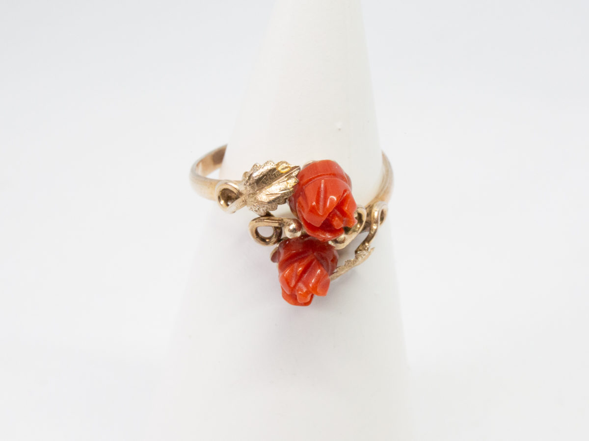 Continental carved coral roses ring. Pretty Continental gilt silver ring set with two carved red coral roses mounted on gilt silver leaves. Open band design. Size P. Hallmark to outside band (worn 800) Will be sent boxed. Main photo of ring on a cone display stand and seen with front forward..