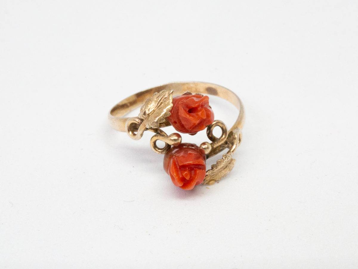 Continental carved coral roses ring. Pretty Continental gilt silver ring set with two carved red coral roses mounted on gilt silver leaves. Open band design. Size P. Hallmark to outside band (worn 800) Will be sent boxed. Photo of ring on a flat surface and shown with front facing forward.