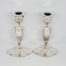 c1920 American Art Deco candlesticks. Stunning pair of shapely Art Deco silver plated candlesticks. Made by Simpson H.M & Co. One candlestick has an uneven base and a slight wobble. Each stick measures approximately 97mm by 75mm at base, 160mm tall at the highest point, 57mm by 48mm across the top and candle slot measures 22mm in diameter. Main photo of both candlesticks shown side by side and width ways on.