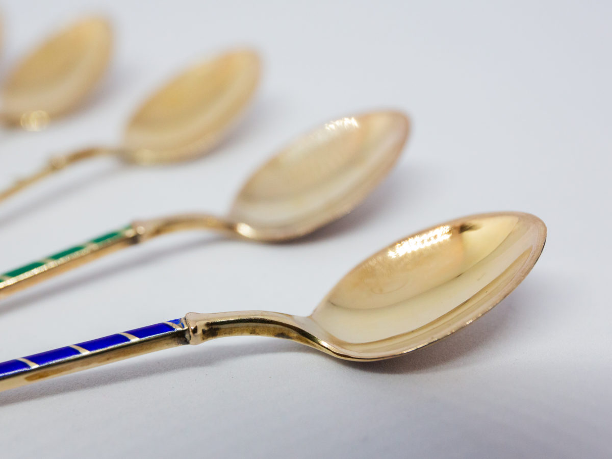Set of 6 mid century coffee spoons. Lovely set of 6 gilt sterling silver and enamel coffee spoons by Egon Lauridsen of Denmark in original case. Each spoon with a different colour enamel to the handle. Hallmarked Ela Denmark Sterling 925S to the back. Each spoon measure approximately 93mm long and weighs 7.6gms. Close up photo of a few spoon bowls