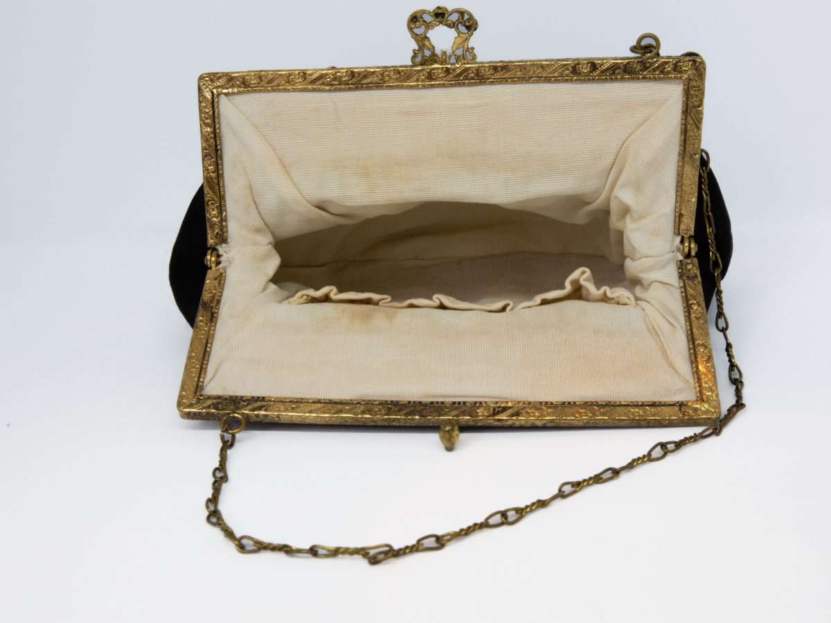 Vintage black satin bag. Very sweet bag in black satin with a gilt metal chain handle and frame studded with coloured stones. c1920s-1930s. In good order for age. Chain drop length approximately 150mm. Photo of bag open and looking into the interior.