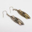 Victorian silver canoe earrings. Very unusual pair of canoe earrings with oar across the top of canoe. One canoe is silver coloured whilst other has slight golden hue and maybe gilded to distinguish 2 sides (Oxford V Cambridge perhaps?) Antique kitemark hallmark to the back of each canoe c1880. (This year being significant in that it is the only time in the history of the boat race that it was postponed for 2 days due to thick fog) Drop length approximately 45mm with canoe measuring approximately 30mm. Earrings weight 2.8gms. Box included. Main photo of earrings laid side by side on a flat surface with silver coloured one in the foreground and distinctively golden hued canoe and oar in the background.