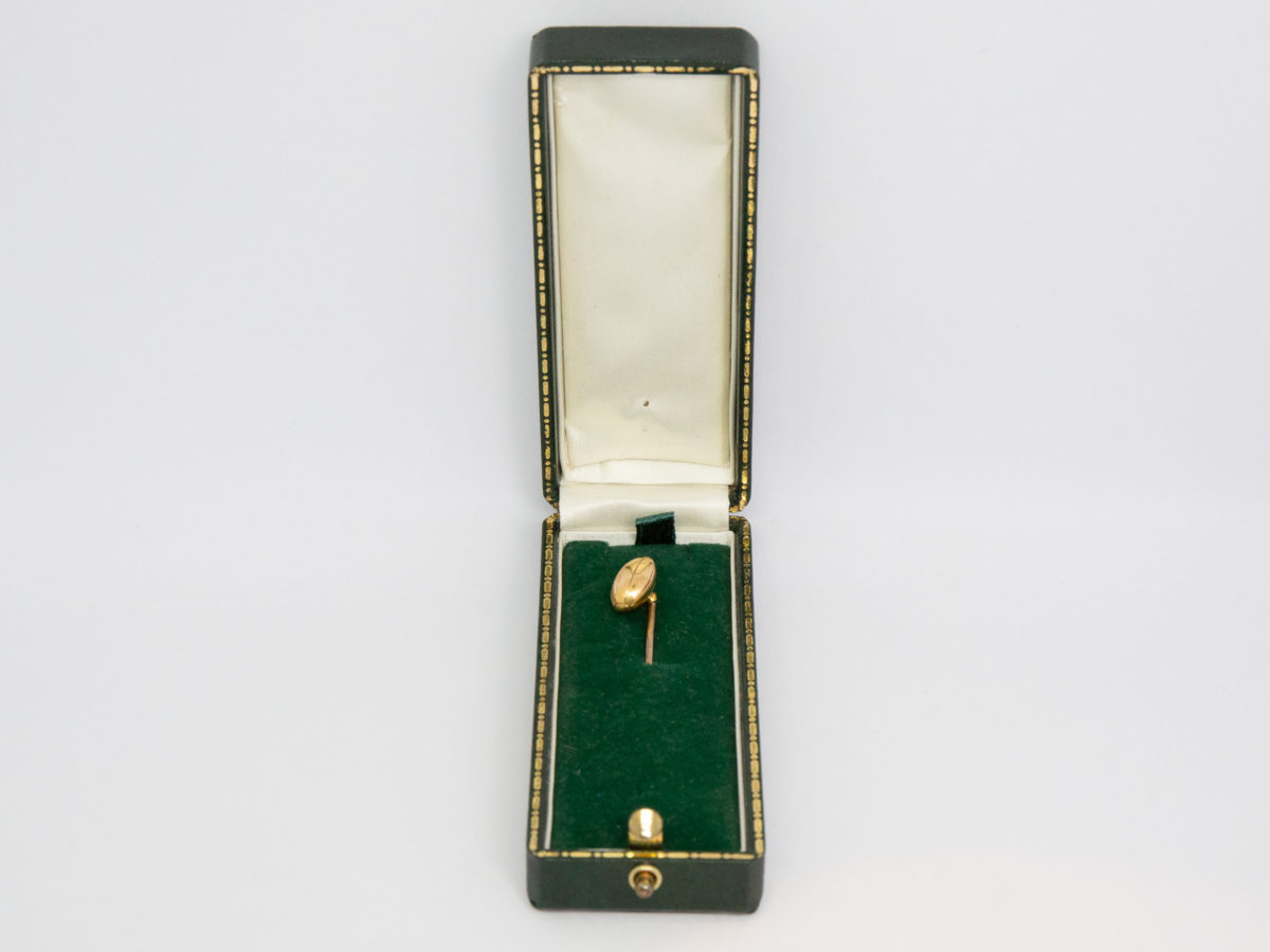 Victorian 15 karat gold stick pin. Beautifully crafted rugby ball stick pin. Hallmarked 15ct to back of ball. Definitely one for the lover of rugby ! Measures approximately 60mm long and weighs 2.5gms. Rugby ball measures approximately 10mm long. Photo of stick pin inside green velvet lined case.