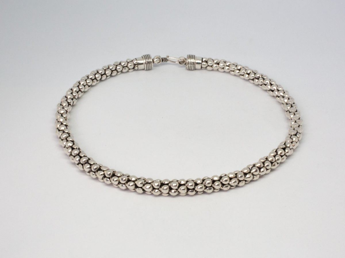 Modern sterling silver necklace. Unusual silver necklace with a bubbles or water droplets like chain. Nice length so closer to neck like a choker. Hallmarked 925 to the link. Photo of necklace fully done up and laid on a flat surface in a circle.