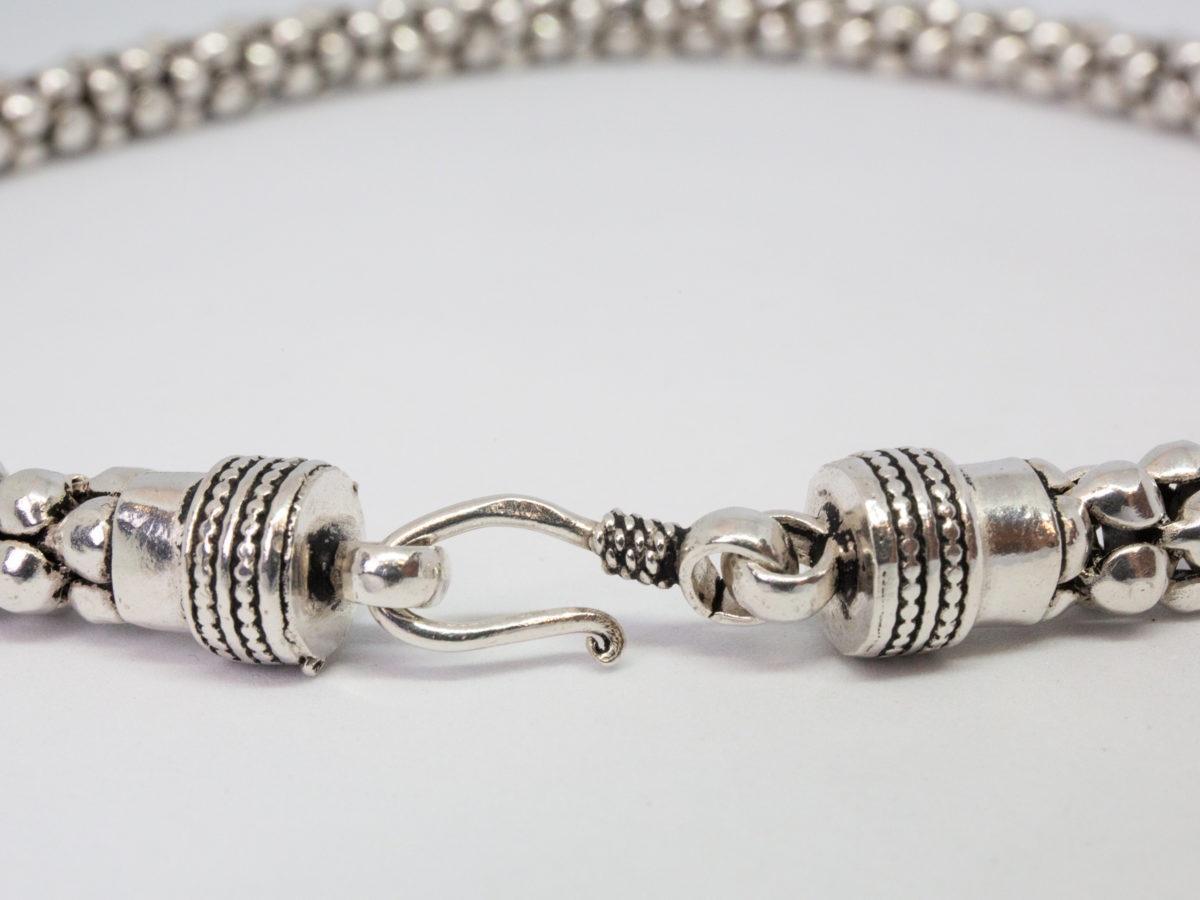Modern sterling silver necklace. Unusual silver necklace with a bubbles or water droplets like chain. Nice length so closer to neck like a choker. Hallmarked 925 to the link. Close up photo of both ends of the clasp area.
