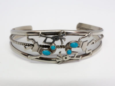 Vintage Navajo silver cuff bracelet. High quality cuff bracelet in sterling silver with Kokopelli characters decorated with Sleeping Beauty turquoise stones. Hallmarked sterling to the back and signed by the designer Ella Peter. Really lovely piece of Native American jewellery. Cuff opening measures 30mm but can be slightly manipulated. Main photo of cuff bracelet front showing the Kokopelli musicians and Sleeping Beauty turquoise stones