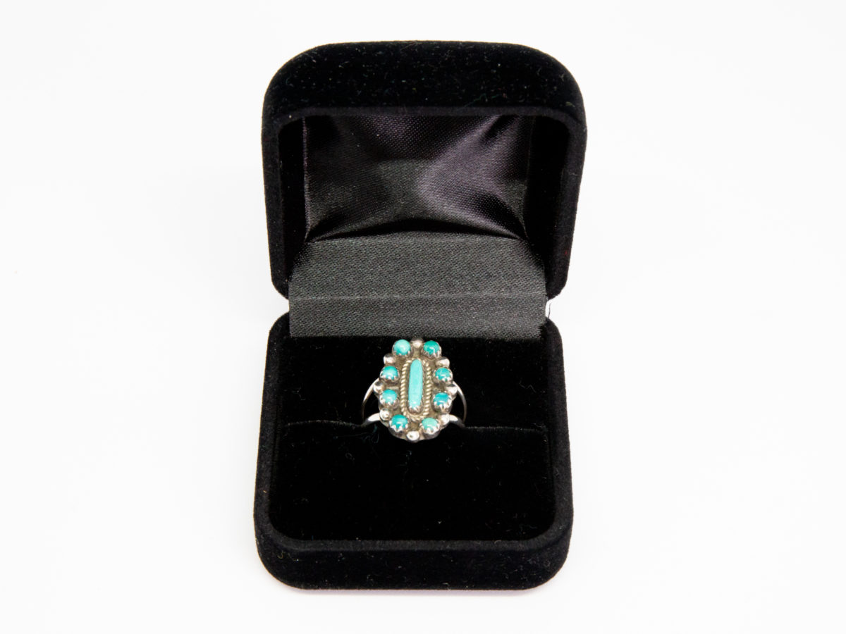 Vintage Navajo silver and turquoise ring. Sterling silver ring set with Bisbee blue turquoise. Stamped sterling with initials BB to the back for Benson Boyd. Wonderful example of fine Native American craftmanship. Ring size M / 6. Ring front measures 22mm by 15mm. Ring weight 4.3gms. Photo of ring displayed in a black velvet ring jewellery box.