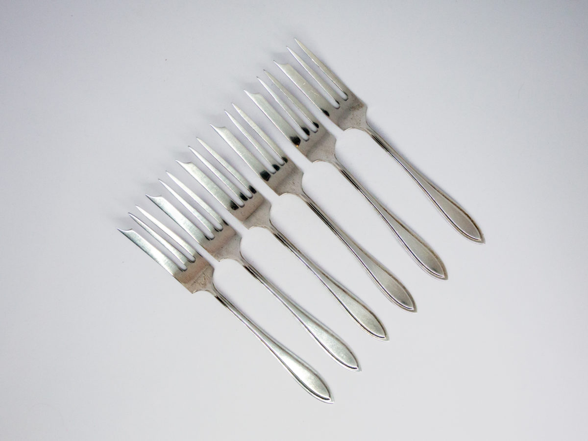 Cased set of sterling silver cake forks. Nice set of 6 cake/dessert forks in original case. Each fork is hallmarked to the back of handle for Birmingham assay c1941. Made by William Suckling Ltd of Albion and Vyse Street. Each fork weighs 16.5gms and measures 128mm long. Photo of forks only displayed outside of the case and laid diagonally with tine ends to the top left corner and handles to the bottom right corner.