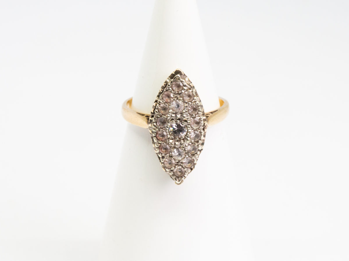 Vintage 9 karat gold and spinel ring. Pretty 9 karat gold ring with spinel stones set on a oval shaped mount with hearts to the side. Hallmarked 9ct on inside band. Ring size N / 6.75. Ring weight 4gms. Main photo of ring displayed on a cone shaped stand and shown from the front.