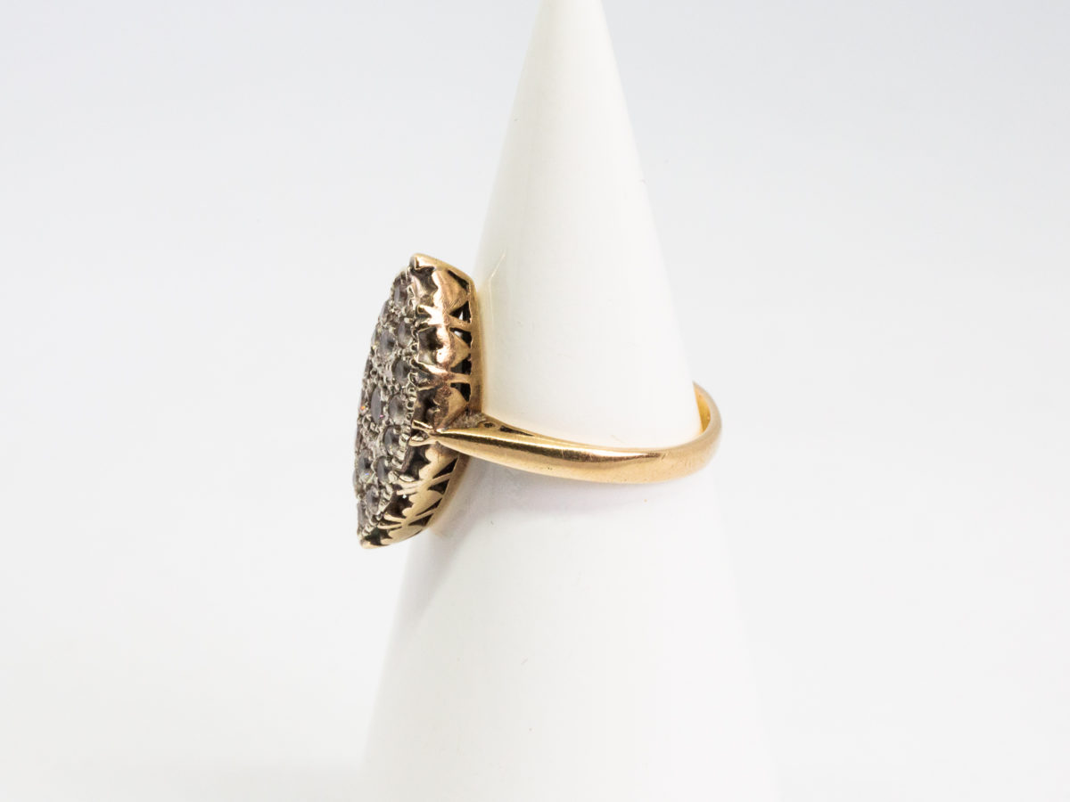 Vintage 9 karat gold and spinel ring. Pretty 9 karat gold ring with spinel stones set on a oval shaped mount with hearts to the side. Hallmarked 9ct on inside band. Ring size N / 6.75. Ring weight 4gms. Photo of ring displayed on a cone shaped stand with ring front facing left of photo.
