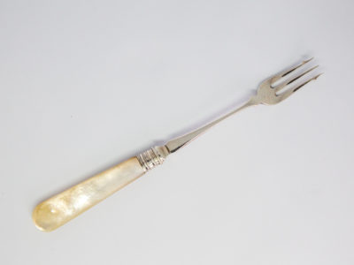Antique silver and mother-of-pearl pickle fork. Fine sterling silver pickle fork in excellent condition with a mother-of-pearl handle. Full hallmark to the back of fork for Sheffield assay c1899 and made by James Dixons & Sons. Main photo showing fork laid diagonally across the page with prong end in the top right hand corner of picture. Curve side of prong up.